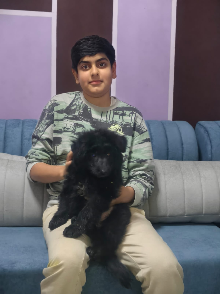 Happy young customer with black puppy