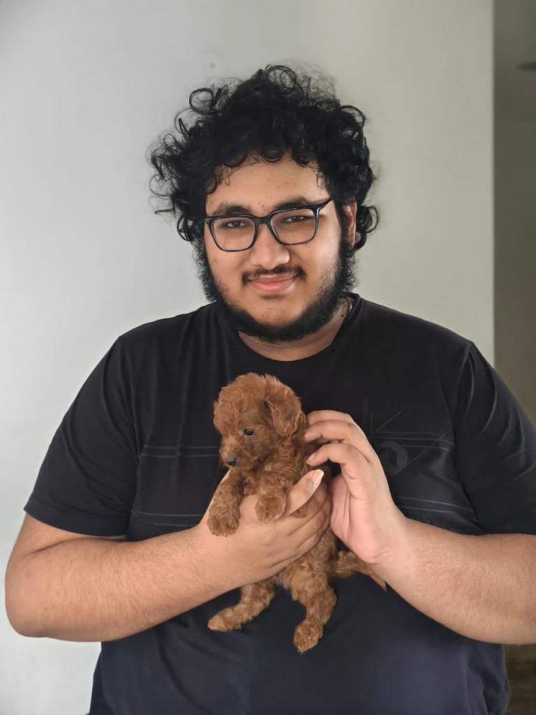 Customer smiling with Toy Poodle puppy